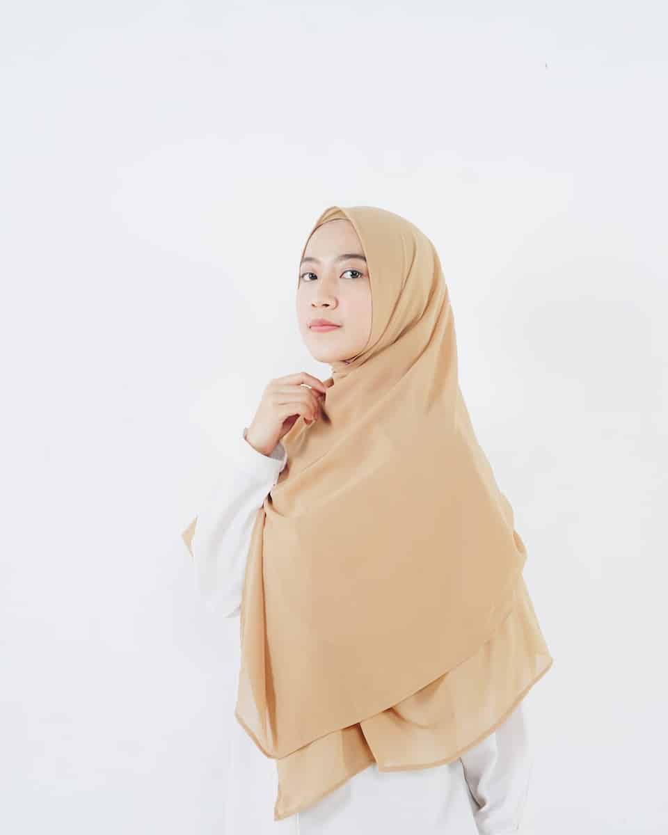 woman in beige hijab standing
